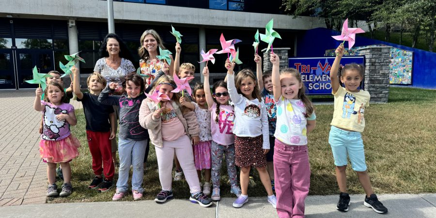 Elementary students with their pinwheels for peace